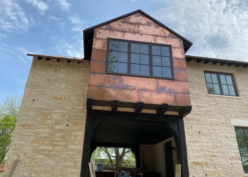 Copper metal panel facade on a stone building for Skylight Installation in Irmo