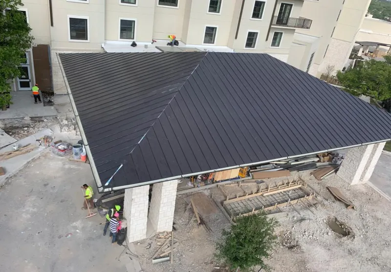 Metal roofing installation team working on a commercial building in Irmo